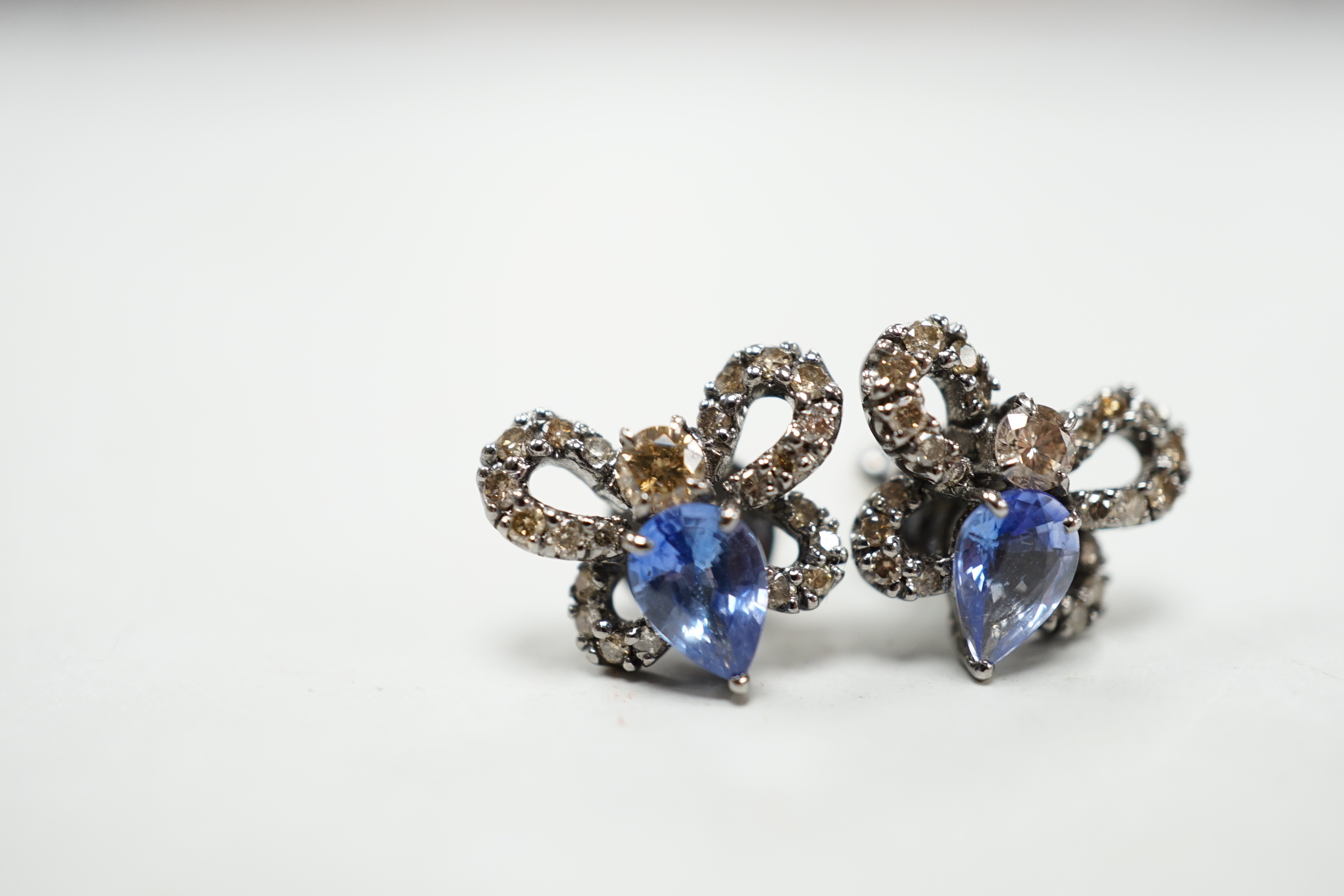 A pair of 750 white metal, sapphire and diamond cluster set bug earrings, width 13mm, gross weight 3.8 grams.